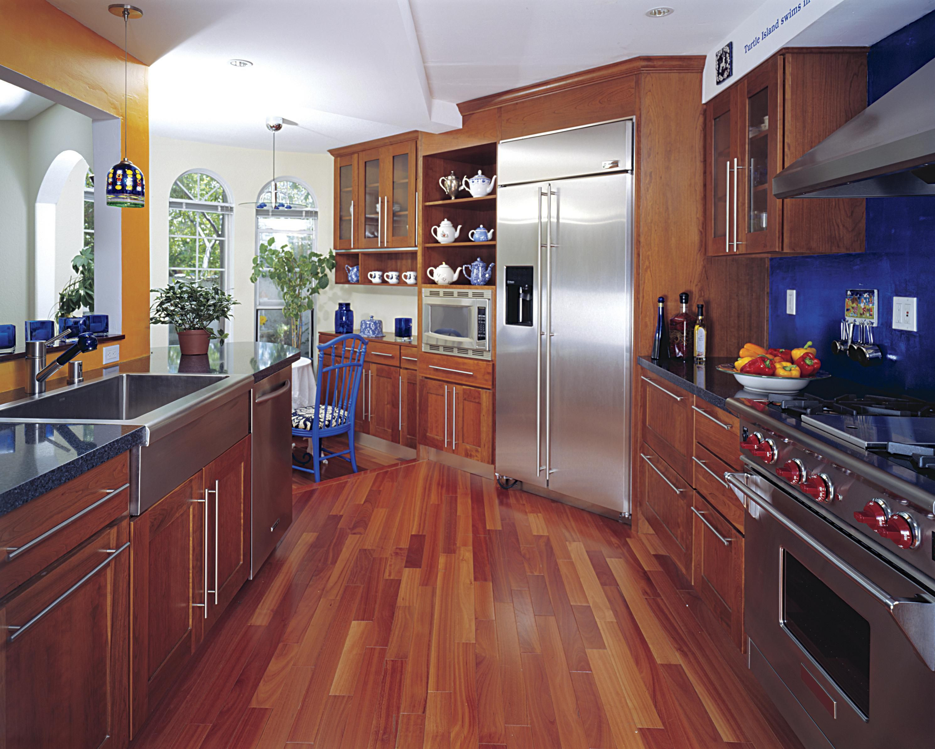 light hardwood floor in kitchen with white cabinet